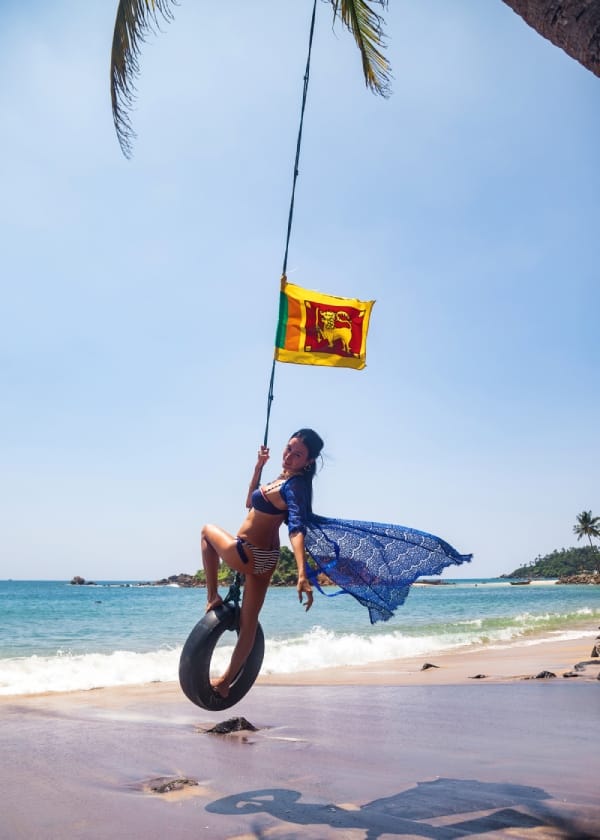 happy-woman-wear-in-blue-swimsuit-swing